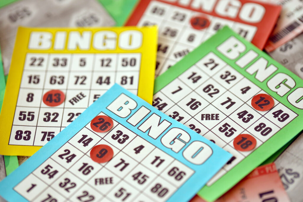 Stack of colorful bingo cards and game chips.